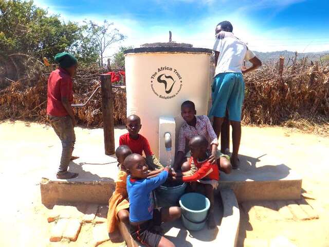 Children at an AquAid Elephant Pump drawing clean water